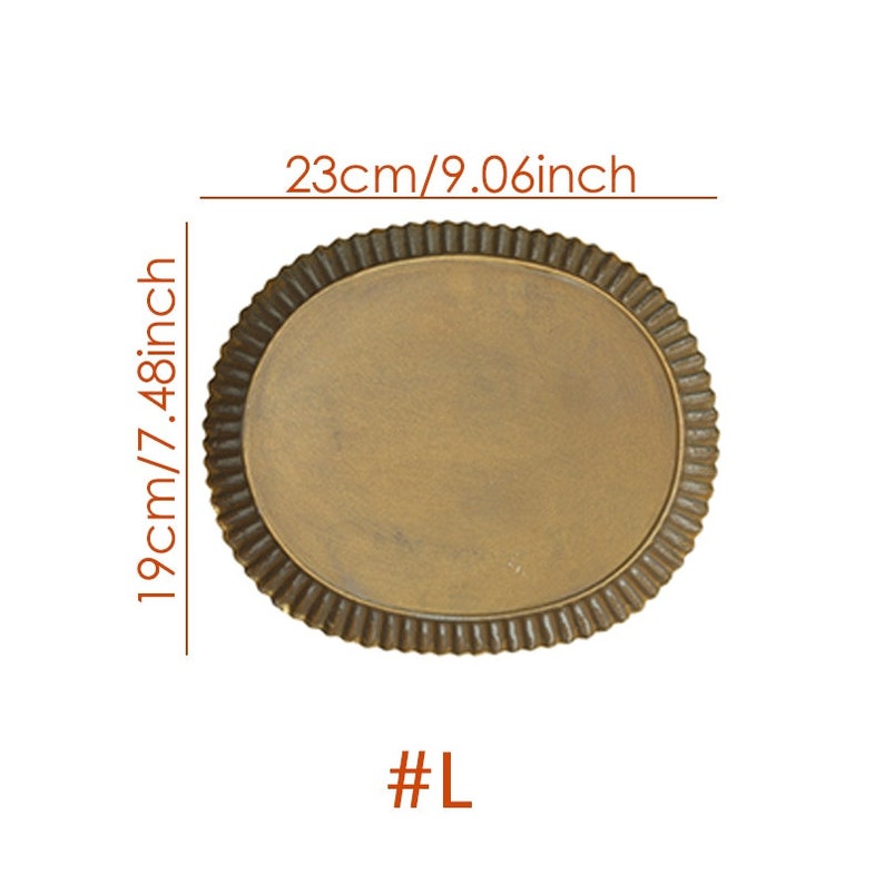 May include: A large, round, gold-colored serving tray with a scalloped edge. The tray measures 9.06 inches in diameter and 7.48 inches in height. #L
