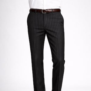May include: Black pinstripe trousers with a brown leather belt and dark brown dress shoes. The trousers have vertical white stripes and a classic, tailored fit. The shoes are polished and shiny.
