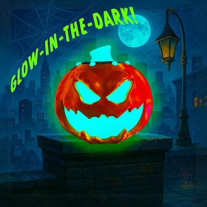 May include: A glowing orange jack-o'-lantern with a carved face, emitting a bright turquoise light. The words "GLOW-IN-THE-DARK!" are written above the pumpkin. The scene is set against a cityscape backdrop with a full moon.