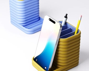 May include: A blue and yellow desk organizer set. The set includes a blue container with a yellow lid and a yellow organizer with a smartphone, pen, and pencil. The organizers have a ribbed design.