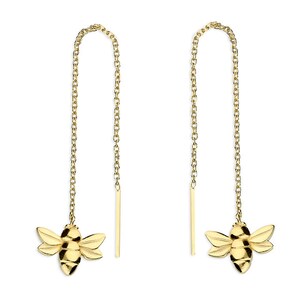 May include: A pair of gold bee charm earrings with a delicate chain. The earrings are designed to be worn as a drop style.