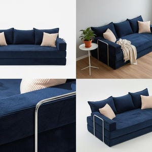 May include: A navy blue corduroy sofa with three back cushions and two beige throw pillows. The sofa has a modern design with a metal frame and is suitable for a living room or lounge area.