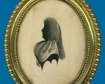 May include: A black and white silhouette portrait of a person with a large, elaborate hairstyle, framed in a gold oval frame.