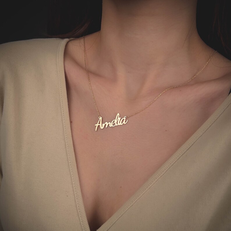 k name gold pendant