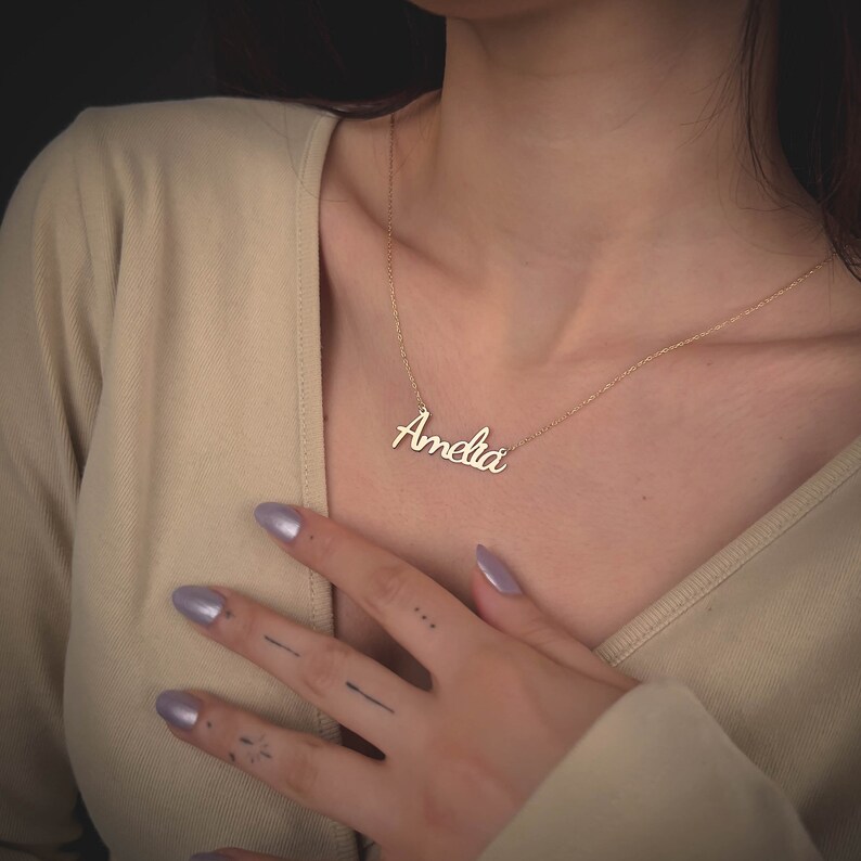 k name gold pendant