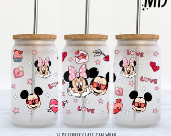 May include: Three 16 ounce glass can wraps with a Valentine's Day theme featuring Mickey and Minnie Mouse. The wraps are white with pink hearts, stars, and the word "LOVE".