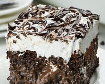 May include: A slice of chocolate cake with a white frosting layer swirled with dark chocolate. The cake sits on a white plate with a fork, showcasing a rich, moist texture and a decadent dessert.