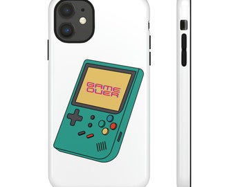 May include: A white phone case featuring a teal retro handheld game console design. The game console has a yellow screen with the words "GAME OVER" in pink and purple. The case has black trim.