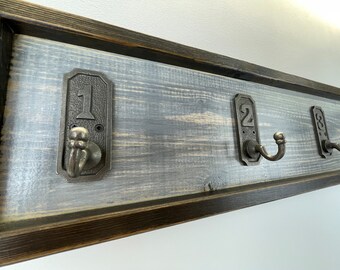 Handmade hand painted cast iron number hooks on painted pine with worn frame