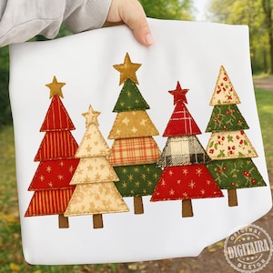 May include: A white fabric item featuring a design of six Christmas trees. Each tree is a different color and pattern, including red stripes, gold stars, plaid, and floral prints. The trees are topped with gold or red star ornaments.