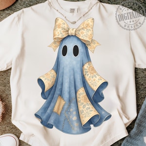 May include: White t-shirt featuring a whimsical ghost design. The ghost is blue with a floral bow and patches. The design has a vintage, hand-drawn aesthetic, perfect for Halloween or everyday wear. The shirt is made of a soft, comfortable material.