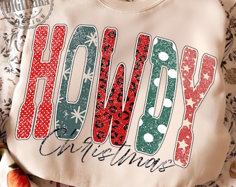 Könnte beinhalten: Cremefarbenes Sweatshirt mit dem Text "HOWDY Christmas". Das Wort "HOWDY" ist in einem Used-Design mit roten Punkten, Leopardenmuster, Schneeflocken und Sternen gehalten. Das Wort "Christmas" ist kursiv geschrieben.