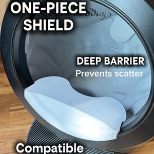 May include: A black and gray cat litter box with a light blue shield. Text on the image reads: "HYGIENIC ONE-PIECE SHIELD", "DEEP BARRIER Prevents scatter", and "Compatible With LR4". The litter box has a deep barrier design.