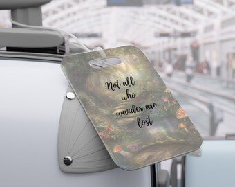 May include: A luggage tag with a forest scene and the quote "Not all who wander are lost".