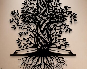 May include: A black metal wall art piece featuring a cross intertwined with tree branches and leaves, emerging from an open book with visible roots extending downwards. The design is symmetrical, showcasing intricate cutouts of foliage and root systems.