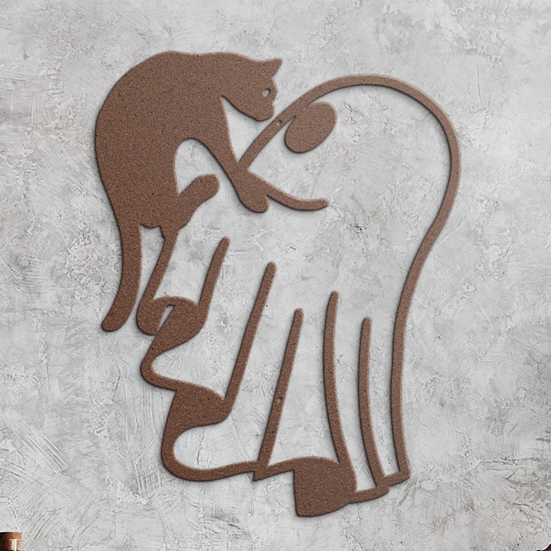 May include: A brown metal wall art piece featuring a continuous line silhouette of a cat perched atop a ghost shape. The design is crafted from a single piece of textured brown metal, forming the outlines of both figures in a connected, fluid form.