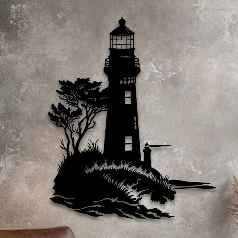 May include: A black metal wall art piece featuring a silhouette of a lighthouse standing on a rocky cliffside with a tree, crashing waves at the base, and a small secondary structure extending to the right side of the main lighthouse tower.