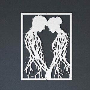 May include: White metal wall art depicting two figures in profile, their heads touching. The figures' bodies are formed by intricate, branch-like patterns, set within a rectangular frame. The artwork is a minimalist representation of connection and intimacy.