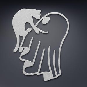 May include: A silver-coloured metal wall art piece featuring a continuous line silhouette of a cat interacting with a ghost. The design is flat, with a textured metallic finish, showcasing the cat reaching towards the ghost's rounded head.