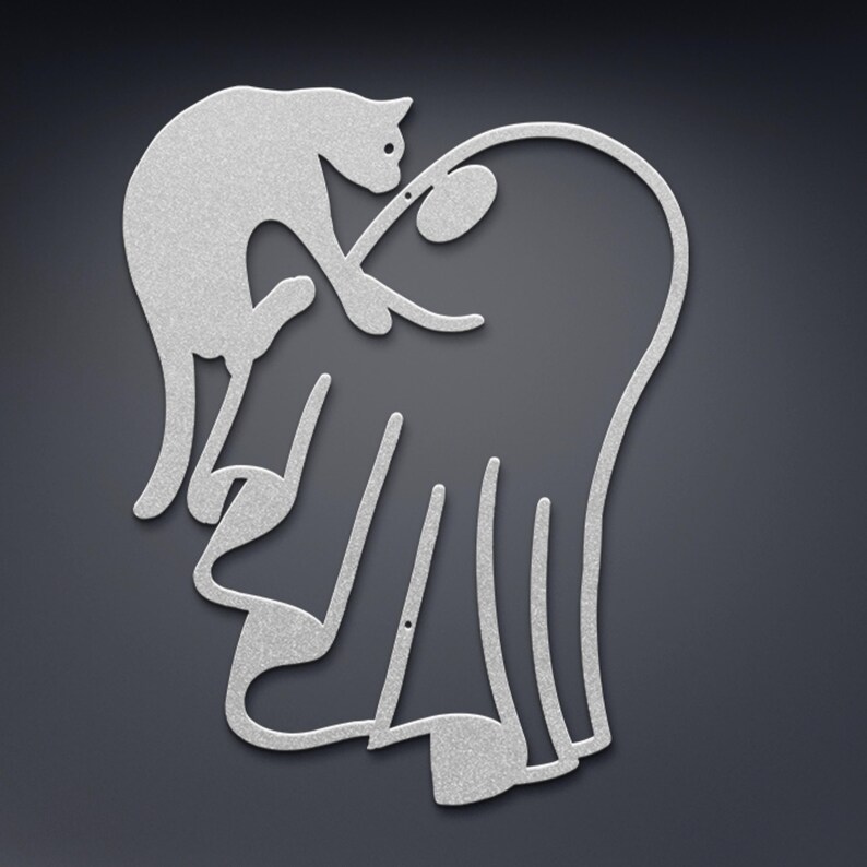 May include: A silver-coloured metal wall art piece featuring a continuous line silhouette of a cat interacting with a ghost. The design is flat, with a textured metallic finish, showcasing the cat reaching towards the ghost's rounded head.