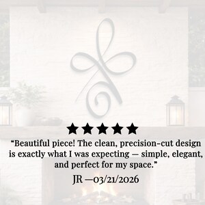 May include: A gray metal wall art piece with a flowing, abstract design. The image includes a five-star rating and a customer review that reads, "Beautiful piece! The clean, precision-cut design is exactly what I was expecting - simple, elegant, and perfect for my space."
