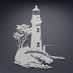 May include: A silver-coloured metal wall art piece featuring a detailed silhouette of a lighthouse standing on a rocky cliffside with a tree and crashing waves at the base. The design includes cutouts for the lantern room and windows.
