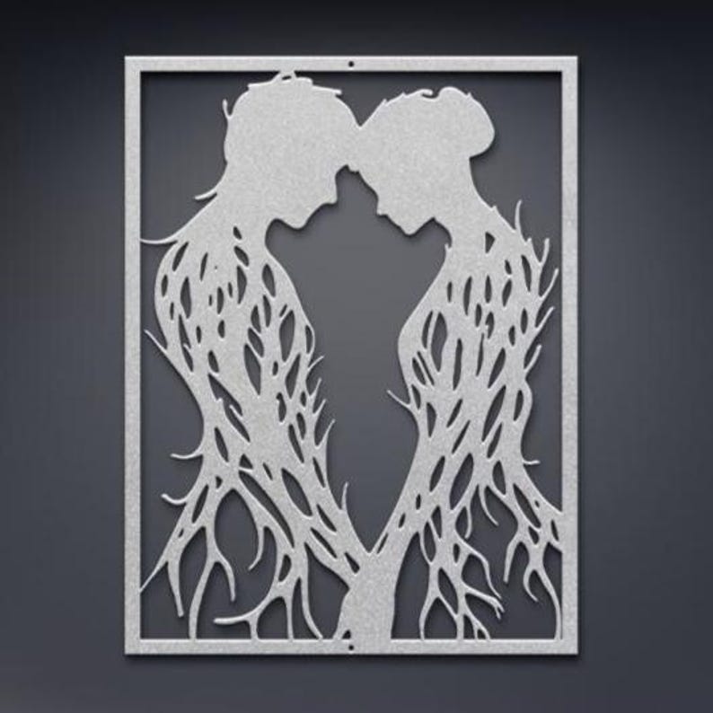 May include: A silver metal wall art piece featuring two silhouetted figures in an embrace. The figures' bodies are intricately designed with a tree-like pattern, and the artwork is framed within a rectangular border. The background is a dark gray.