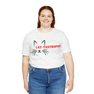 May include: White t-shirt with a green cat silhouette and the text "CAT-TASTROPHY" in red.