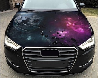 May include: A black car with a galaxy-themed hood wrap. The wrap features a purple and blue nebula with a small planet and scattered asteroids.