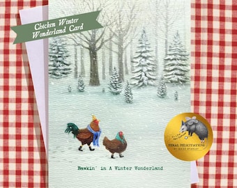 May include: A greeting card featuring a snowy forest scene with two chickens wearing scarves and hats. The text reads Chicken Winter Wonderland Card and Bawkin' in A Winter Wonderland. A gold circular sticker shows an opossum with wings.