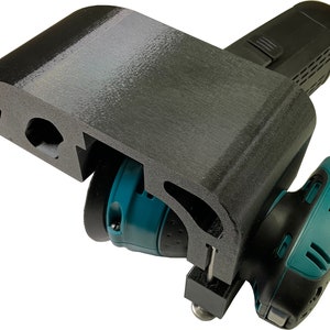 May include: A black 3D printed stand designed to hold a teal and black power sander. The stand has a curved shape and a slot for the sander's cord.