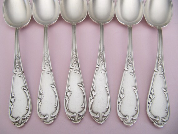 Ornate Silver Teaspoons, Four Spoons with Floral Handles, Arranged in a  Fan-like Manner and Connected