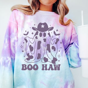 May include: A tie-dye sweatshirt with a purple ghost wearing a cowboy hat and the text "BOO HAW" in purple.