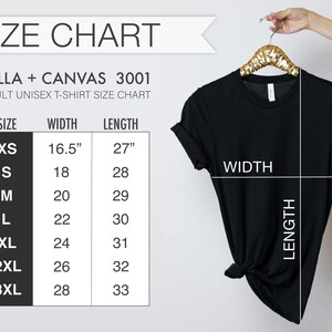 May include: Black t-shirt hanging on a gold hanger, with a size chart to the left. The size chart shows measurements for XS to 3XL, with widths from 16.5 inches to 28 inches and lengths from 27 inches to 33 inches. The text "SIZE CHART" is at the top.