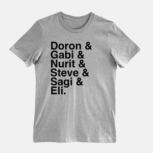 May include: A heather grey t-shirt with black text that reads "Doron & Gabi & Nurit & Steve & Sagi & Eli."