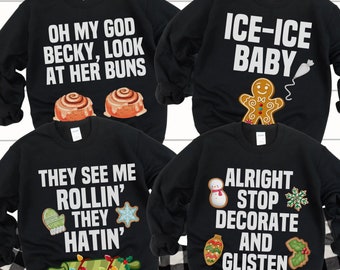 May include: Four black Christmas sweaters with different holiday-themed designs and text. The sweaters feature a gingerbread man, a snowman, a rolling pin with lights, and cinnamon rolls. The text on the sweaters reads "Ice-Ice Baby", "Alright Stop Decorate and Glisten", "They See Me Rollin' They Hatin'", and "Oh My God Becky, Look At Her Buns".