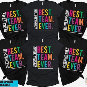 May include: Six black t-shirts with white text and colorful accents. Each shirt features the text "BEST. TEAM. EVER." with a different job title above the text. The job titles are: Office Staff, Administration, Special Education, Cafeteria Crew, Specials Squad, and Custodial Crew.