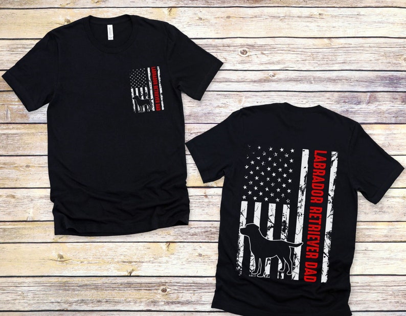 May include: Black t-shirt with a distressed American flag design and the text "Labrador Retriever Dad" in red.