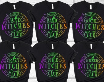 May include: Six black t-shirts with a rainbow gradient design. Each shirt features a different witch-themed graphic with the text "Proud Member of the Witches Club" and a witch's hat, broom, and bats.