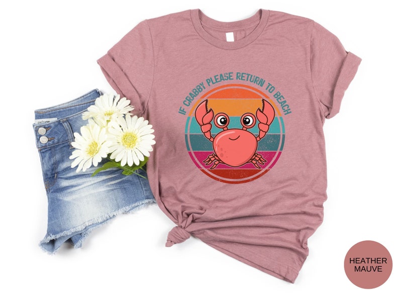 May include: Heather mauve t-shirt with a retro-style graphic of a crab with the text "If Crabby Please Return to Beach".