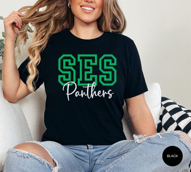 May include: Black t-shirt with a green "SES Panthers" graphic.