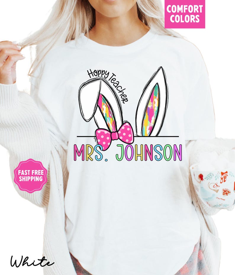 May include: White t-shirt with a colorful bunny ear design and the text "Hoppy Teacher" and "MRS. JOHNSON".