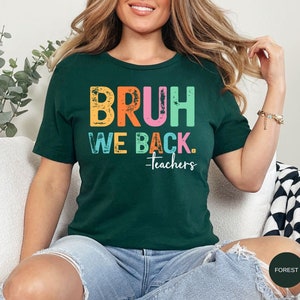 May include: A green t-shirt with the text "BRUH WE BACK. -teachers" in rainbow colors. The text has a distressed, vintage look.