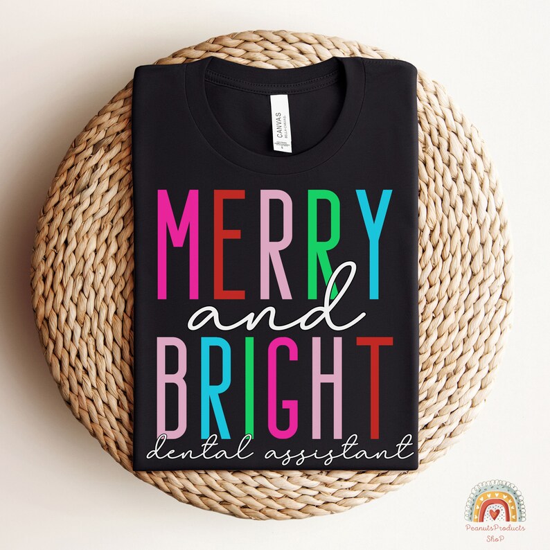 May include: Black t-shirt with the text "Merry and Bright dental assistant" in colorful letters.