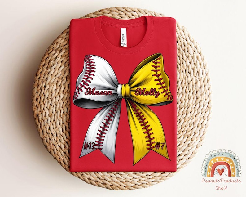 May include: Red t-shirt with a white and yellow softball bow. The bow has the names "Mason" and "Molly" on it, and the numbers "#13" and "#7" on the bottom.