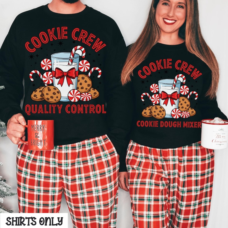 May include: Black sweatshirts with the text "Cookie Crew" and a graphic of milk, cookies, and candy canes. The sweatshirts are paired with red plaid pajama pants. One person holds a red mug that says "Merry & Bright".