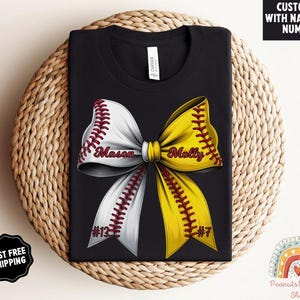 May include: Black t-shirt with a white and yellow softball bow with red stitching. The bow has the names "Mason" and "Molly" written on it. The numbers "#13" and "#7" are also on the bow.