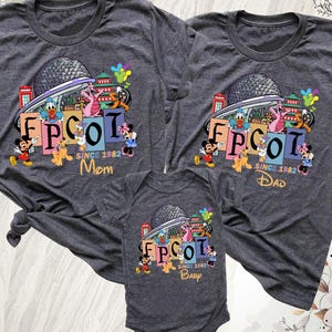 May include: Three gray t-shirts and a baby onesie featuring a colorful EPCOT design with Mickey Mouse, Donald Duck, and other Disney characters. The shirts are labeled "Mom" and "Dad", and the onesie says "Baby". The text "EPCOT SINCE 1982" is also present.