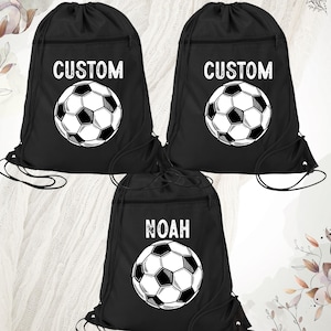 May include: Three black drawstring bags with a soccer ball design. One bag says "CUSTOM" and the other two say "CUSTOM" and "NOAH".