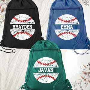 May include: Three drawstring backpacks in black, blue, and green. Each bag features a distressed baseball design with a name in white. The black bag says "BRAYDEN", the blue bag says "EMMA", and the green bag says "JAVAN".